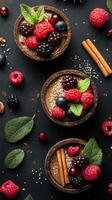 Delicious dessert bowls with fresh berries and herbs arranged artistically on a dark surface photo