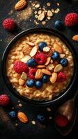 Healthy breakfast bowl with oats, berries, and almonds served on a dark surface photo