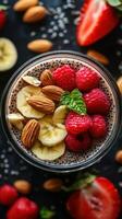Delicious chia pudding topped with bananas, raspberries, and almonds on a dark background photo