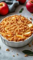 Homemade apple crisp dessert topped with golden crumble, ready for serving in a cozy kitchen setting photo