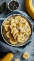 Healthy breakfast bowl with bananas, chia seeds, and creamy base served in a stylish bowl at home photo