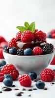 Delicious dessert with fresh berries and mint leaves served in a white bowl on a light background photo