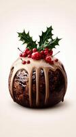 Christmas pudding topped with decorative holly and berries on a neutral backdrop photo