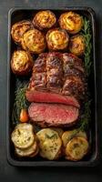 Juicy roast beef with crispy potatoes served fresh from the oven photo
