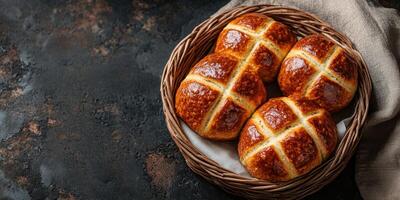 Freshly baked hot cross buns arranged in a cozy wicker basket on a rustic table photo