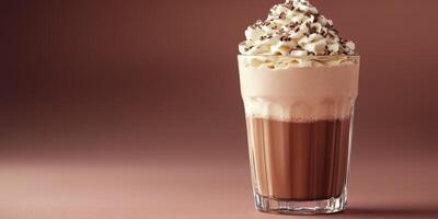Indulgent whipped cream topped chocolate drink served in a glass with chocolate shavings sprinkled on top photo