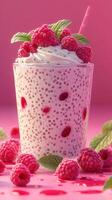 Refreshing raspberry drink with creamy texture and vibrant colors served in a clear glass photo