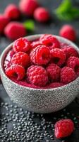 Fresh raspberries in a patterned bowl with chia seeds on a dark surface create a vibrant and healthy snack photo