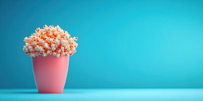 Creative display of popcorn in a pink pot against a teal background for a fun kitchen or party decor photo