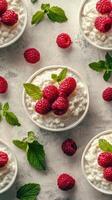 Fresh raspberries atop creamy cottage cheese served in bowls with mint on a light textured surface photo
