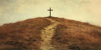 Cross at the top of a hill surrounded by golden grass under a cloudy sky creates a serene atmosphere for reflection and peace photo