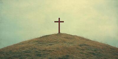 Cross stands prominently on a grassy hill under a cloudy sky at dusk creating a peaceful and reflective atmosphere photo