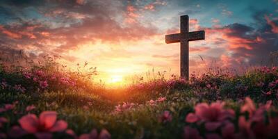 Sunset over a serene landscape with a cross surrounded by blooming flowers photo