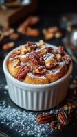 Delicious freshly baked dessert topped with nuts and powdered sugar ready to be served photo