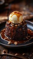 Warm dessert with caramel sauce and vanilla ice cream served on a rustic wooden table at a cozy restaurant during evening hours photo