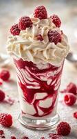 Delicious dessert featuring whipped cream and raspberry sauce served in a glass on a textured surface photo