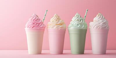 Colorful milkshakes in pastel shades displayed against a soft pink background photo