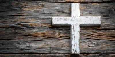 Rustic wooden cross rests against an aged wooden surface, highlighting faith and simplicity in a tranquil setting photo
