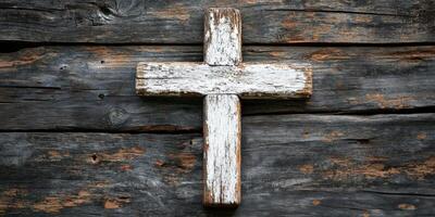 Rustic wooden cross displayed on weathered wooden background showcasing religious symbolism and craftsmanship photo