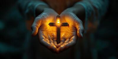Hands holding glowing cross symbolizing faith and hope in a serene, dark setting photo