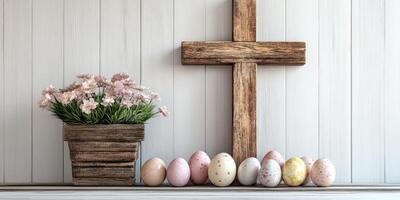 Decorative cross with pastel Easter eggs and flowers in a rustic setting during springtime photo