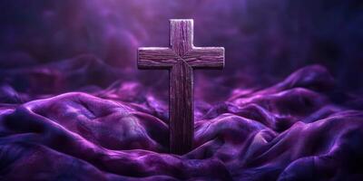 Wooden cross surrounded by deep purple fabric creating a spiritual atmosphere photo