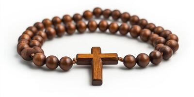 Wooden rosary beads with a cross displayed on a light background for spiritual reflection and prayer photo