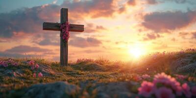 Sunset over a wooden cross adorned with flowers in a tranquil landscape photo