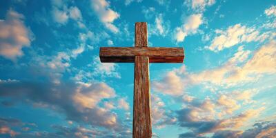 Wooden cross against a vibrant sky filled with clouds during sunset photo