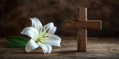 White lily and wooden cross placed together on a textured surface in a serene and contemplative setting photo