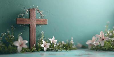 Wooden cross adorned with flowers and greenery on a turquoise background during springtime photo