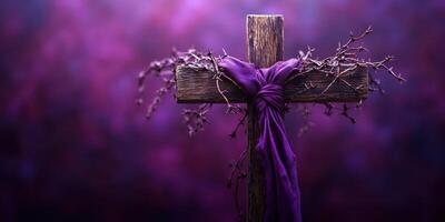 Wooden cross adorned with purple fabric and thorns in a serene purple backdrop conveying a spiritual atmosphere photo
