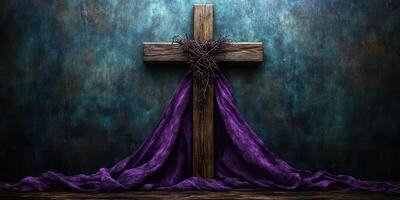 Wooden cross adorned with thorny crown and purple drapery in a dimly lit space representing passion and reflection photo