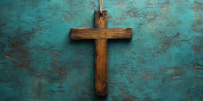 Wooden cross hanging on a textured blue background in a calm and serene setting photo