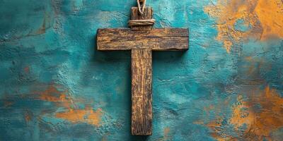Distinctive wooden cross displayed against a textured turquoise and orange wall in a serene indoor setting photo