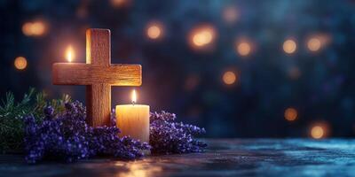 Wooden cross and candles with lavender flowers create a serene atmosphere for reflection and remembrance during evening hours photo