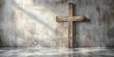 Wooden cross stands against a weathered concrete wall in a serene, softly lit space photo