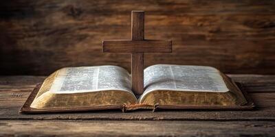 Wooden cross resting on an open Bible on a rustic wooden table in a serene setting photo