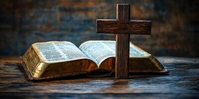 Bible and wooden cross displayed on a rustic table in a dimly lit room photo