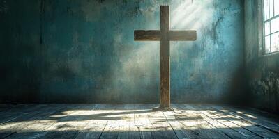 Light streams through a window illuminating a wooden cross in a serene, abandoned room photo