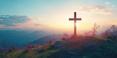 Spiritual sunrise over mountains with a wooden cross standing in the foreground amidst blooming flowers and soft clouds photo