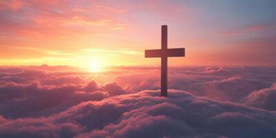 Cross rises above clouds during a breathtaking sunrise over a serene landscape photo