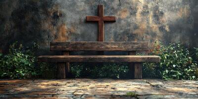 Wooden bench in a tranquil setting with a cross on a weathered wall in the background photo