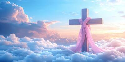 Cross adorned with a pink ribbon stands amidst fluffy clouds at sunset creating a serene and uplifting atmosphere photo