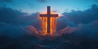 Cross illuminated by a warm glow amidst a serene cloud-covered landscape during twilight hours photo