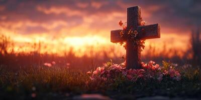 Sunset casts warm glow on a wooden cross adorned with flowers, symbolizing remembrance in a tranquil setting photo