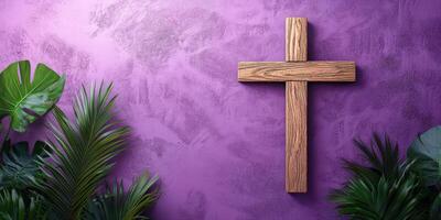 Wooden cross set against a vibrant purple wall with lush green plants creating a serene atmosphere in a modern space photo