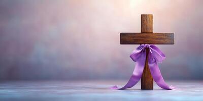 Wooden cross with purple ribbon set against a soft blurred background during a calm and reflective moment photo