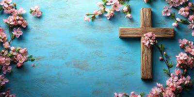Cross decorated with pink flowers on a blue background represents peace and renewal in springtime photo