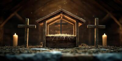 Nativity scene with wooden stable, crosses, and candles illuminated in a rustic setting photo